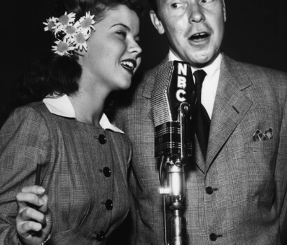 Johnny Mercer singing with NBC microphone.