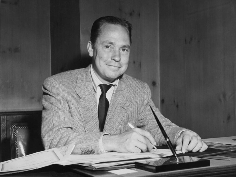 Johnny Mercer writing at his desk.