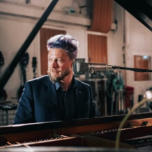 Scheuer playing piano.